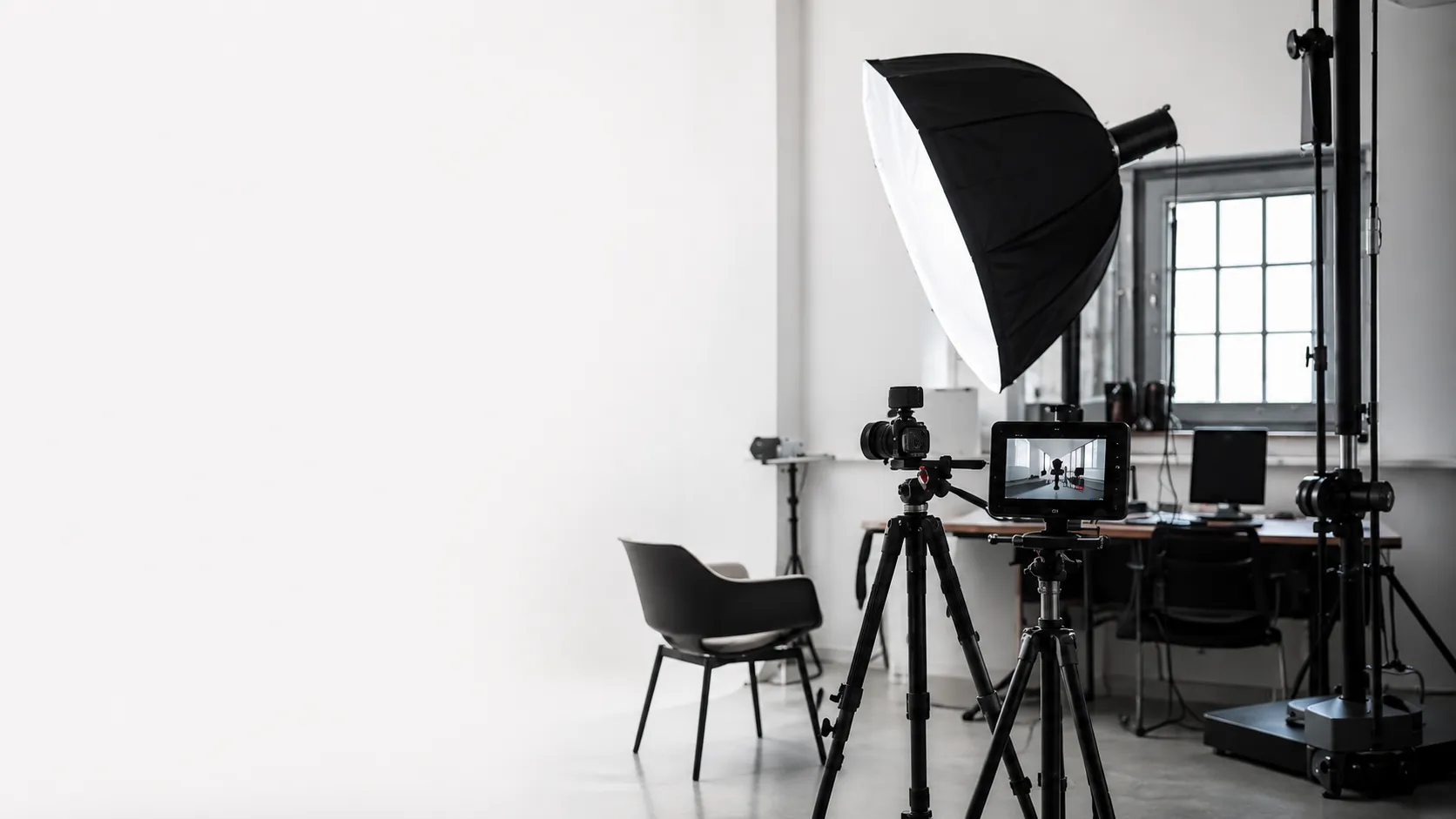 Modern photo studio with camera, softbox and workspace